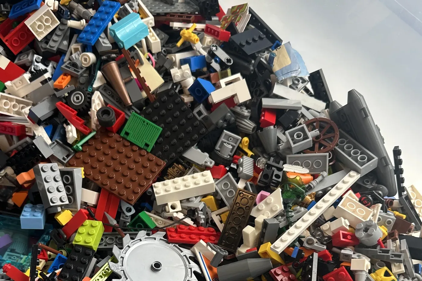 A pile of loose, colourful LEGO bricks on a table, ready to be scanned by a phone app.
