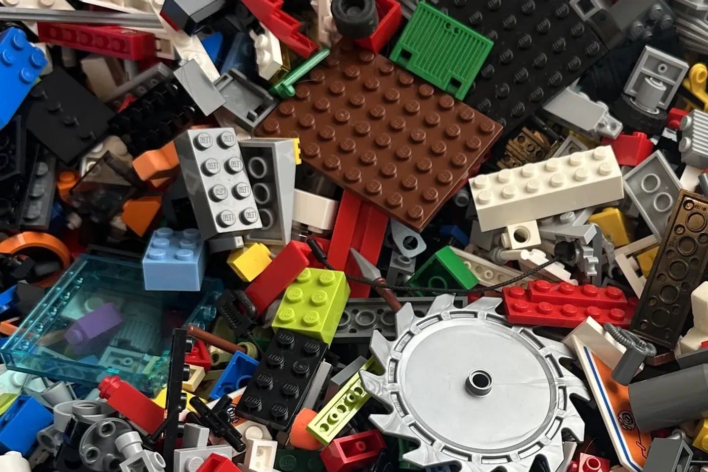 A close view of a tub of loose, mixed LEGO bricks in many colours.