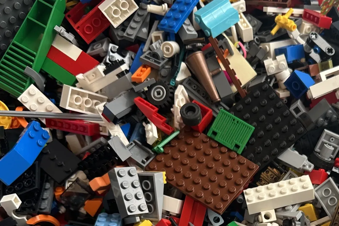 A tub of loose, unsorted LEGO bricks in many colours, waiting to be sorted.