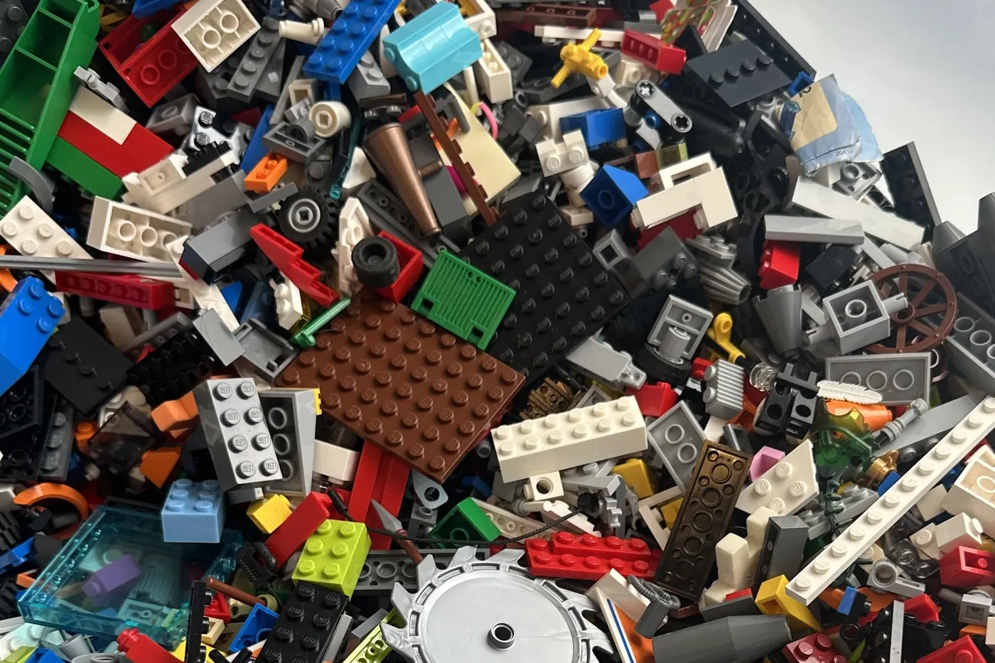 A pile of loose LEGO bricks in many colours, waiting to be sorted into sets and stored.